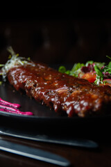 close up of ribs with barbacue dish on a table of a fancy restaurant