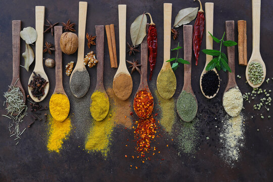 Different kind of spices on a wood background.  Big set of Indian spices on wooden table. Top view, Horizontal image.	Flat lay. 
