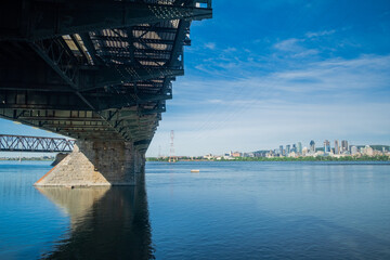 bridge over river with view of downtown skyline