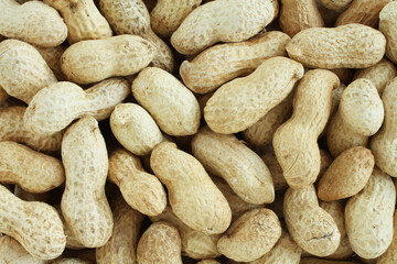 Food background - big peanuts in shells situated arbitrarily