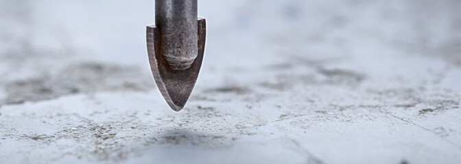 Ceramic drill bit make holes in concrete wall with industrial drill. Building work industry.