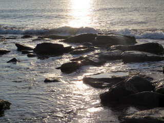 Waves and stones in the sun