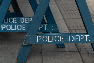 Close up view of several stacked weathered and worn blue wooden road barricade A-frame legs with...