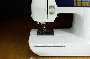 white sewing machine on a wooden table