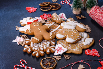 Fototapeta na wymiar Christmas homemade gingerbread cookies on dark concrete table