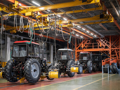 Minsk, Belarus - 30 May 2021: Assembly shop at the tractor production factory. Tractor manufacturing plant. Agriculture-related machines, selective focus