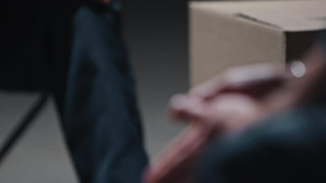 Close-up of the hands of two men dressed in prison clothes
