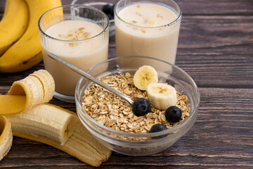 Banana, oatmeal, milk on a wooden background