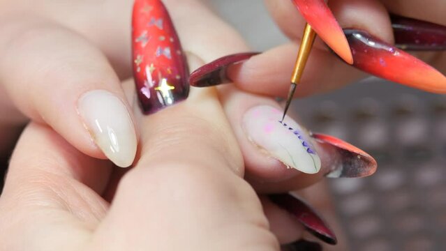 Applying a floral pattern to the nail.