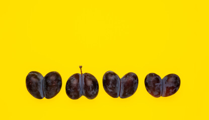 Deformed Fused fruits, ugly prunes in one row. Double fruits heart shaped on yellow background. Concept - Using in cooking imperfect products. Food waste reduction