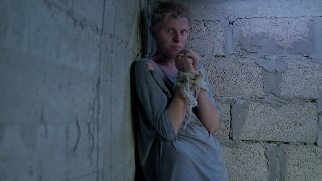 Prisoner in the basement. Bound dirty man