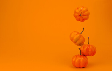 levitating orange pumpkins on an orange banner background