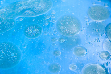 abstract blue background formed by oil drops on water