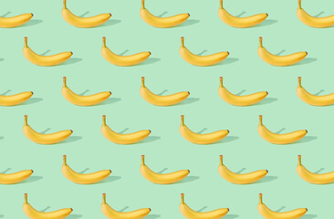 Obraz premium Pattern of bananas on green pastel background