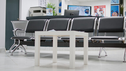 Empty hospital reception waiting room to attend medical checkup visit appointment with specialist. Waiting area in faciliy lobby with seats, healthcare consultation examination for treatment.