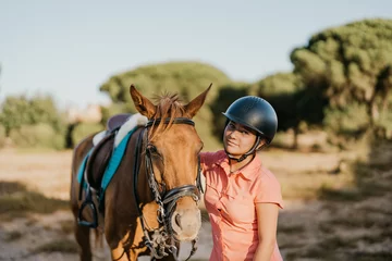 Foto op Canvas portrait of green-eyed girl rider standing next to her pony © Samuel Perales