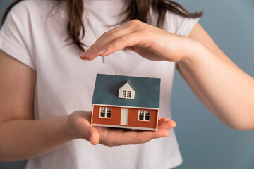 woman hand holding house model
