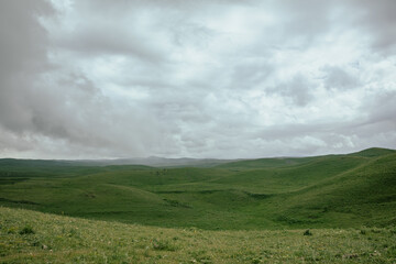 clouds over the green valley