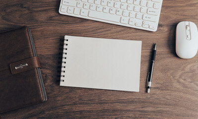 Computer keyboard with notepad on table