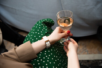 female hands holding a glass of wine