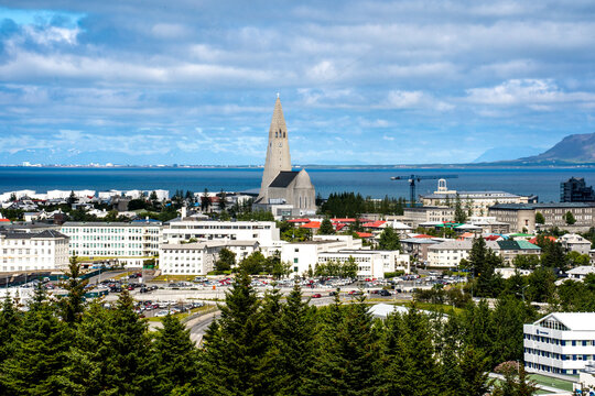 Reykjavik, Iceland - July 4, 2022 A panoramic view of the city's skyline and the iconic Hallgr&iacute;mskirkja church. Seen from rooftop of the Perlan Museum during a summer day.