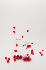 Krill oil red gelatin capsules in transparent flasks on a white background.natural omega three...