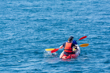 Unidentified sporters in kayak is Calanque de Port-Miou near Cassis, excursion to Calanques national park in Provence, France