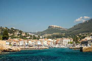 Fototapeta na wymiar Panoramic view on cliffs, blue sea, beach, houses, streets and old fisherman's harbour with lighthouse in Cassis, Provence, France