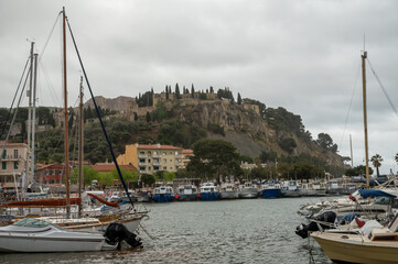 Fototapeta na wymiar Rainy day in South of France, view on old fisherman's port with boats and colorful buildings in Cassis, Provence, France