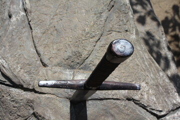 Sword in stone. Stone background. Pattern stone wall background. Natural texture. Beautiful background. Screensaver. The stone is natural.