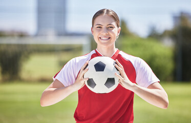 Soccer player, ball and young woman happy to play a fun sports game in a practice stadium field in...
