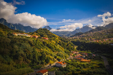 Fototapeta premium Sao Vicente or San Vicente, Madeira, Portugal - October 2021: The fragment view of Sao Vicente village from mountain. Catholic church on front. Aerial drone picture