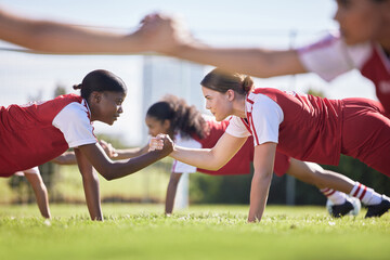 Women soccer, football or team sports holding hands in unity, support or motivation in routine...