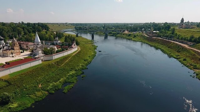 A large Christian church and a bridge across the river are visible on the river bank. Nice summer weather. Aerial photography