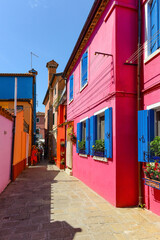 Fototapeta na wymiar People walking in the village. Burano island, Venice, Italy.