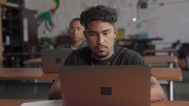 Native American students using their computers in class. Handheld.