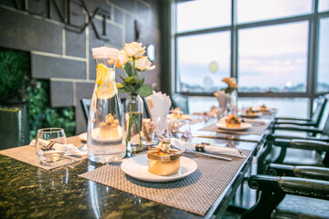 The overall arrangement of the wedding table, including cutlery, flowers, small gifts.