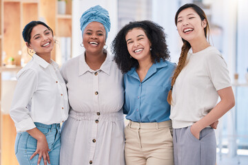 Diverse, happy and smiling portrait of a creative team of designers standing in a modern office. Young successful group of friendly casual coworkers, employees or colleagues posing at the workplace.