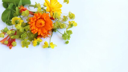 Yellow and orange flowers in a summer composition on a white background. A bright floral arrangement. Background for a greeting card.