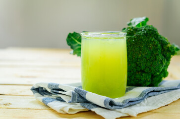 Glass of broccoli juice, broccoli Healthy drink on wood