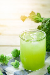 Glass of broccoli juice, broccoli Healthy drink on wood