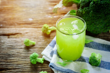 Glass of broccoli juice, broccoli Healthy drink on wood
