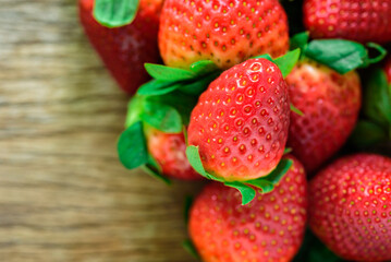 Fresh strawberries on wood, top view