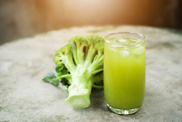 Glass of broccoli juice, broccoli Healthy drink on wood