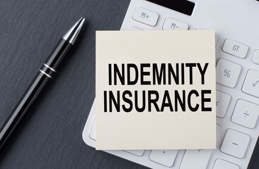 Text IDEMNITY INSURANCE on sticker on calculator, business concept