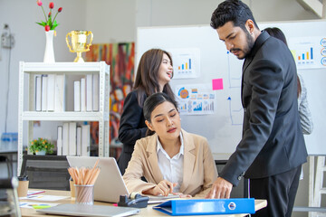 Asian business team male and female colleagues talking at work share ideas  with laptop, Happy colleagues work together on computer in office.