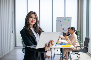 Portrait of Asian beautiful business woman working at the office, using computer. buiness concept.