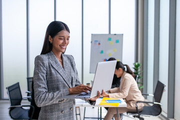 Portrait of Asian beautiful business woman working at the office, using computer. buiness concept.