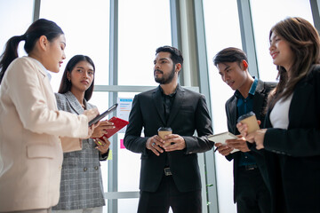 Business team male and female colleagues talking at work share ideas with data report in hands, Happy colleagues work together in office.