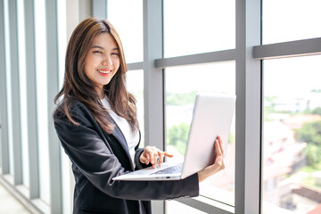 Portrait of Asian beautiful business woman working at the office, using computer. buiness concept.